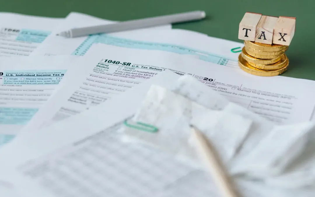 Taxes and Accounting Services in Australia: The Complete Guide for Individuals & Businesses (2026) – Australian accountant reviewing tax documents, financial statements, and business records with a client in a modern office.